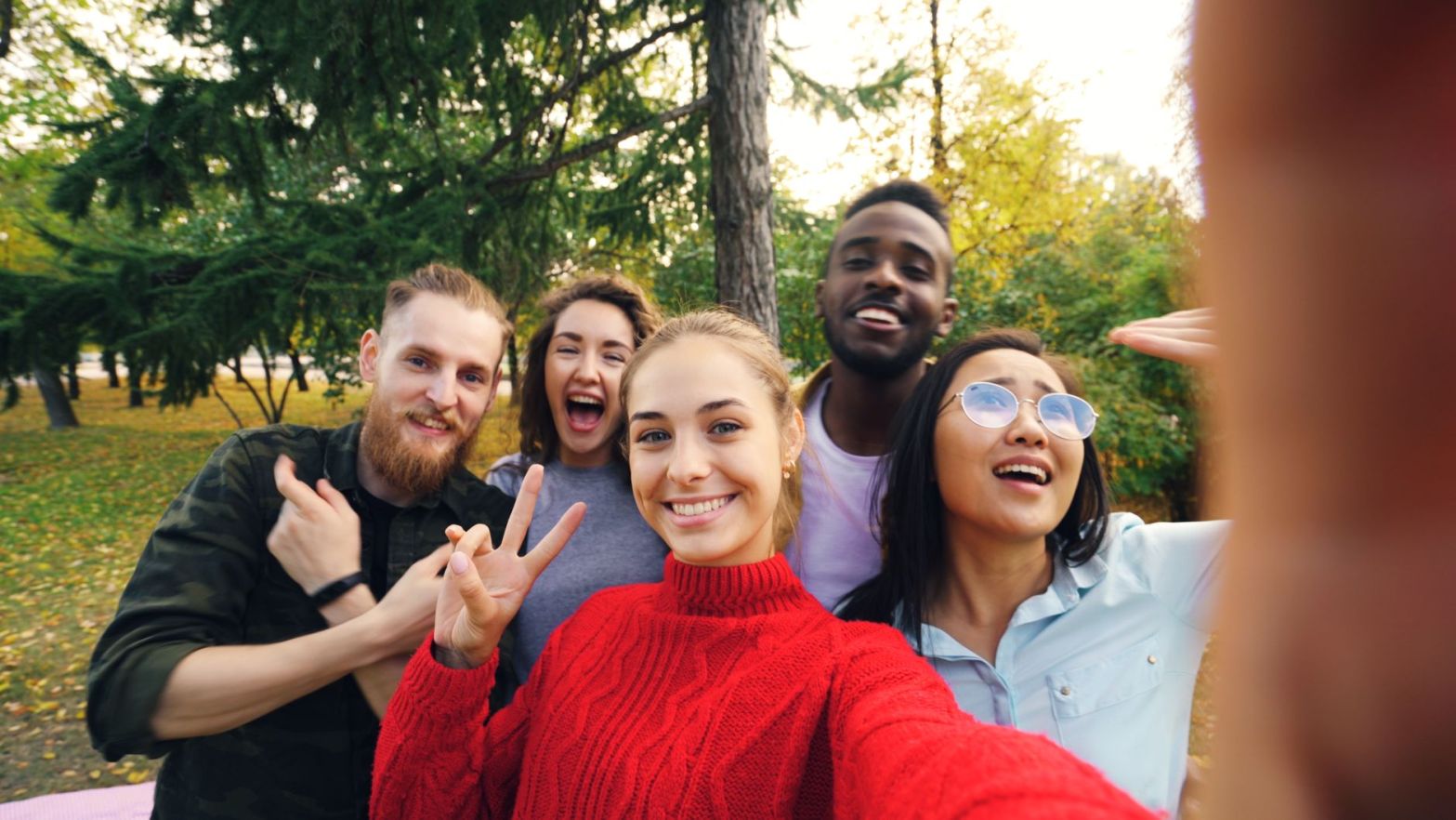 diverse group of friends taking a selfie outdoors