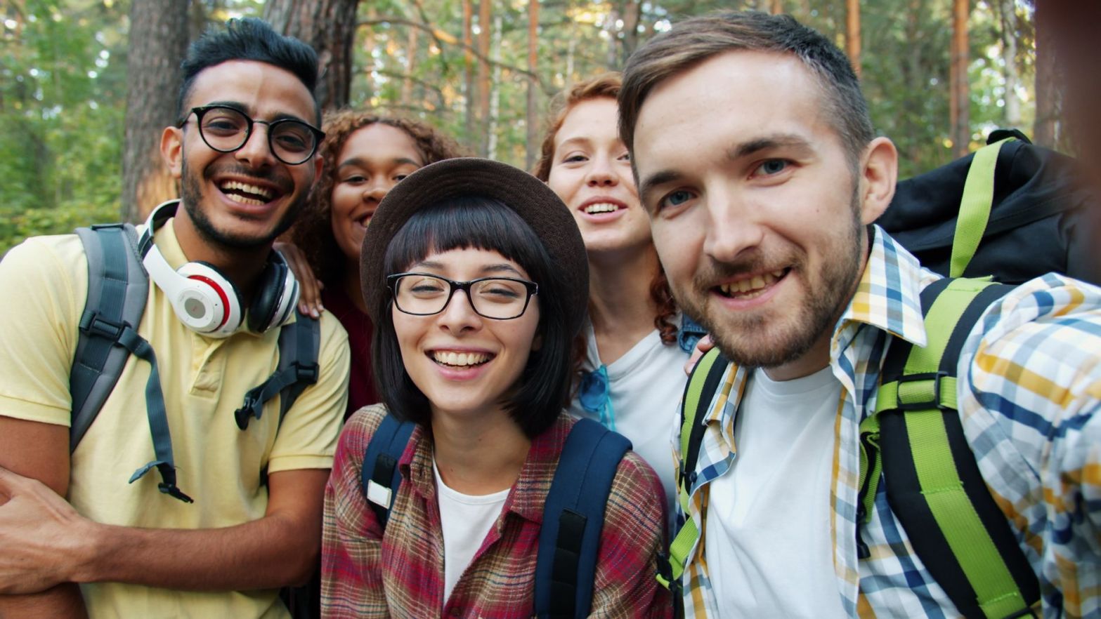 diverse group of friends hiking in forest