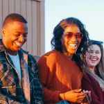 group of friends sitting near lifeguard post